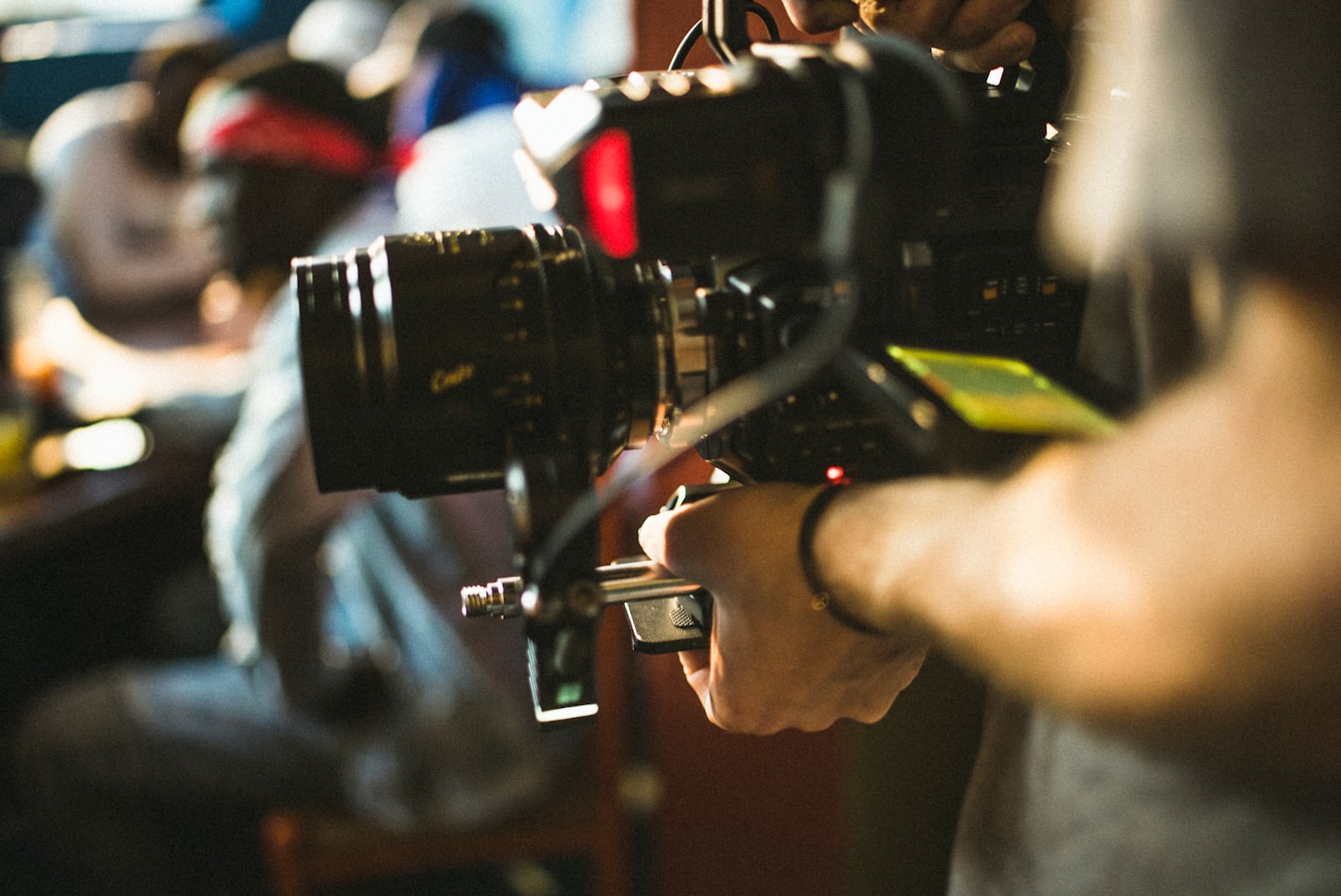 Filmmaker adjusts the settings on a professional cinema camera.