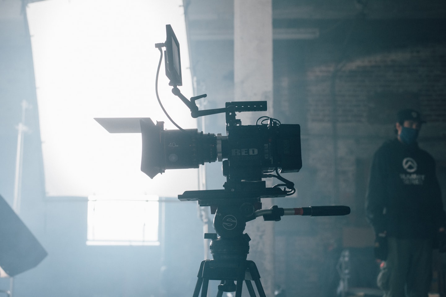 A professional cinema camera on a tripod in a studio.